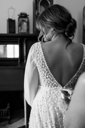 Bride wearing her hair up in a low bun on her wedding day