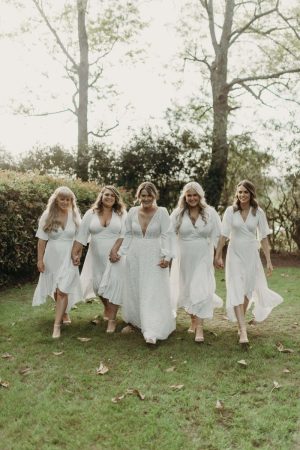Bride and her bridesmaids taking photos at sunset in the Hunter Valley