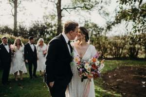 Bride and Groom walk through the picturesque gardens of historic Wallalong House in the Hunter Valley followed by their bridal party