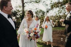 Bridal party enjoying sunset photos at historic Wallalong House