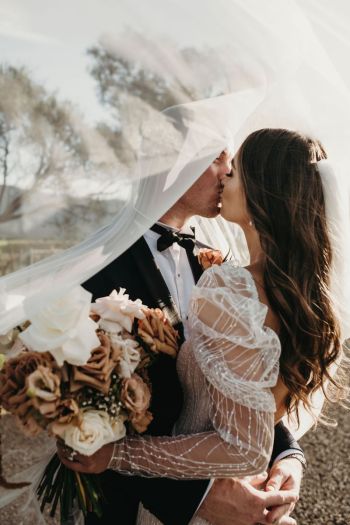 Bride and Groom kiss during sunset photos at Enzo Weddings Hunter Valley