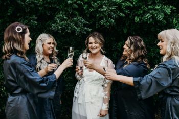 Bride and her bridesmaids sharing champagne at Hunter Valley wedding venue Wallalong House