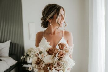 Bride looking out of the window before her ceremony at Hunter Valley wedding venue The Woodhouse Wollombi