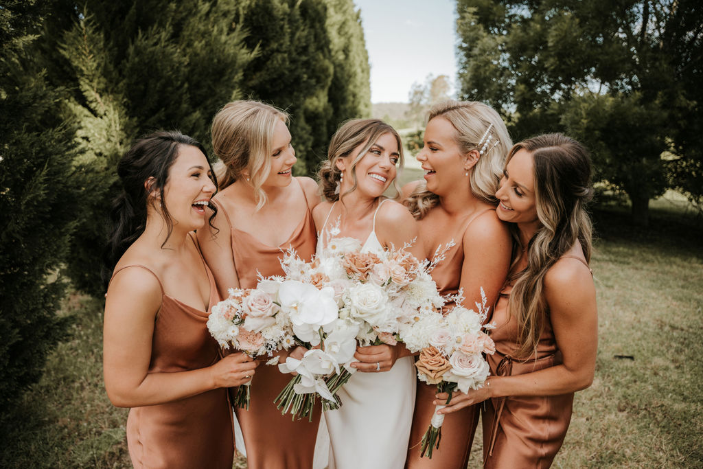 Bridal party wearing Bec and Bridge dresses pose for portraits on the wedding day