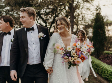 Bride on her wedding day holding colourful bunch of flowers